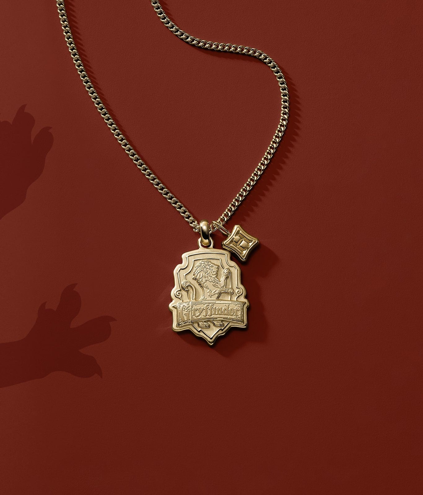 A gold-tone Gryffindor house pendant.