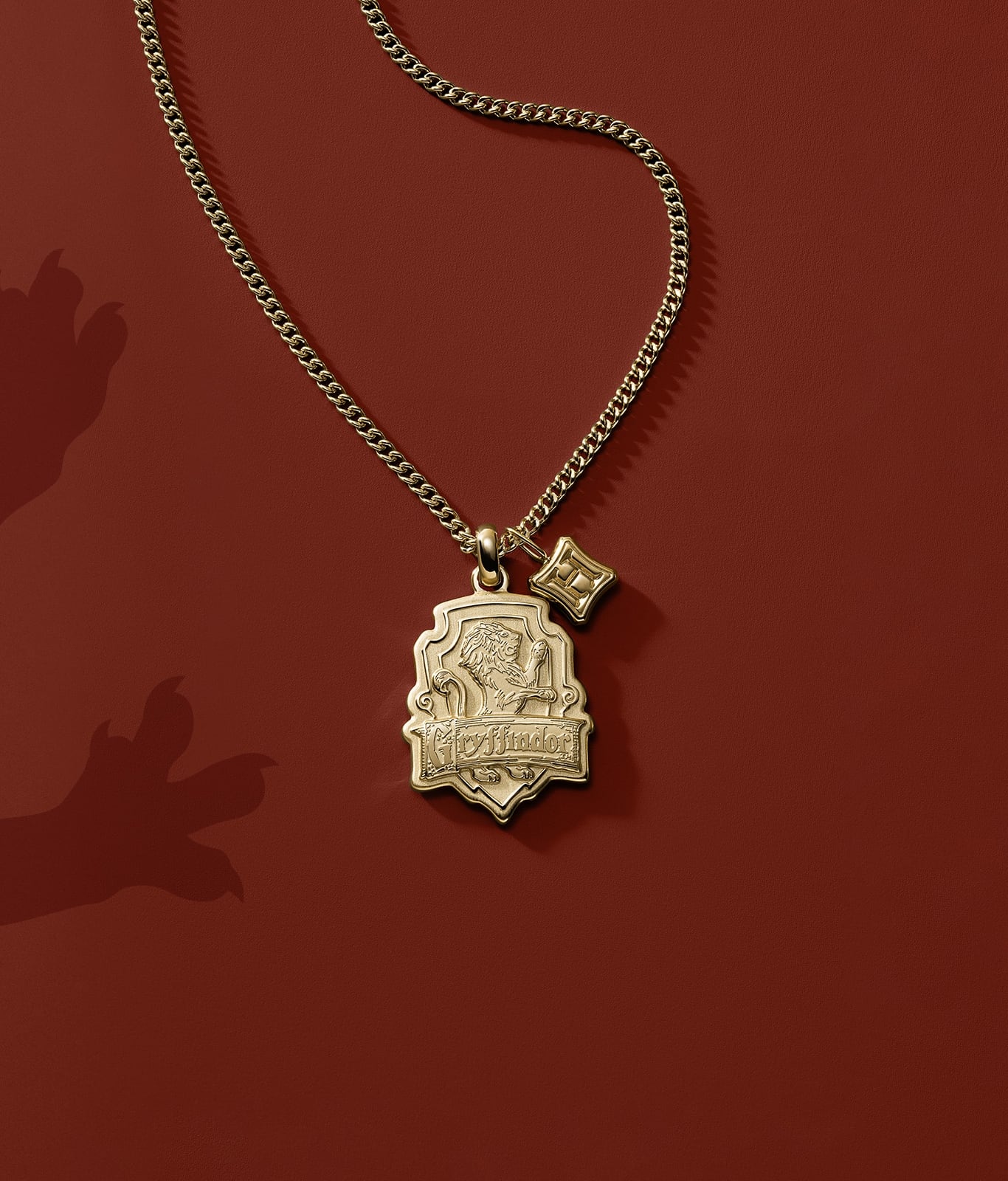 A gold-tone Gryffindor house pendant.