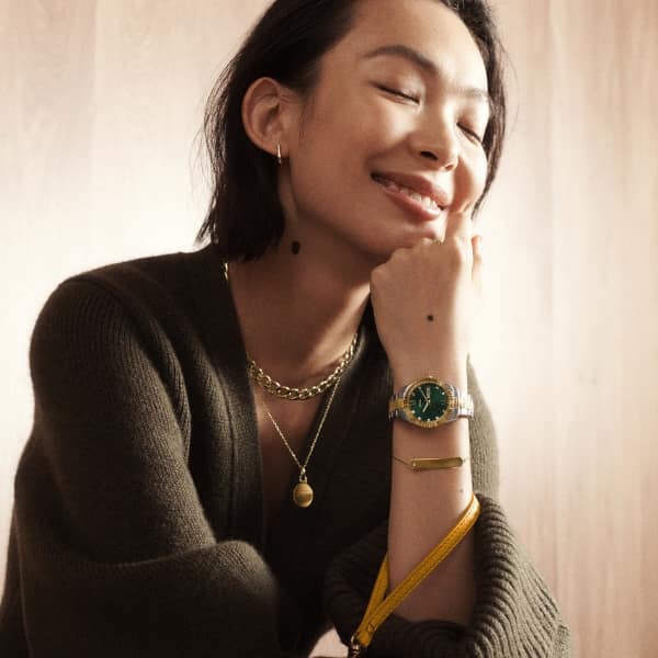 A woman wearing Fossil jewelry.