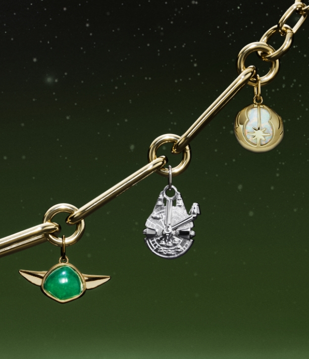 A gold-tone bracelet with charms shaped like Yoda, the Millennium Falcon, C-3PO, R2-D2 and a Lightsabre