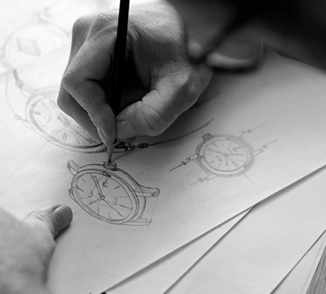 Image of a man sketching out an illustration of a Signature CS-1 watch.