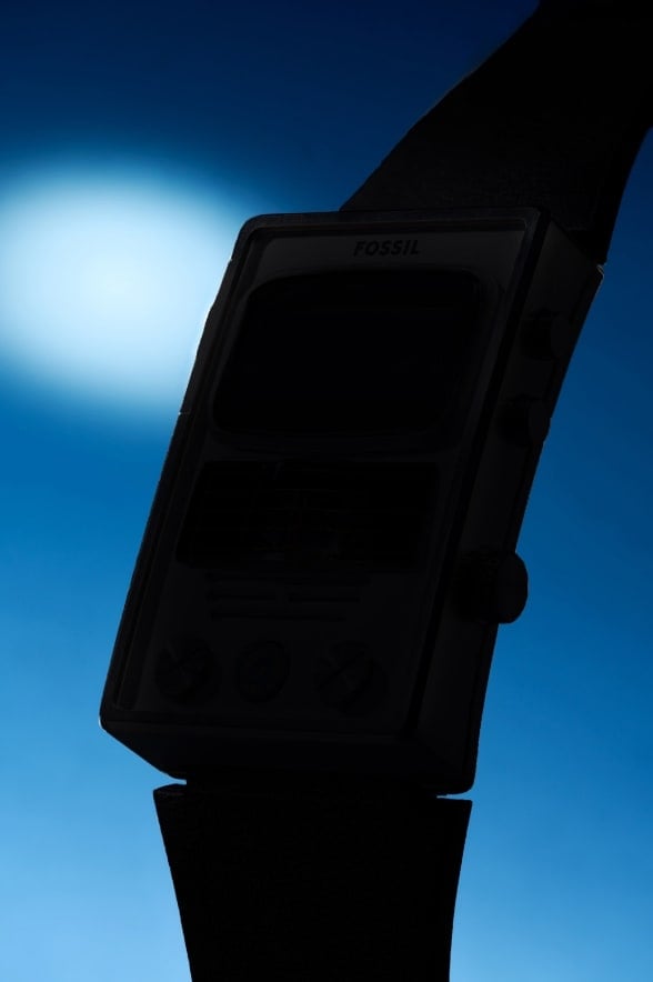 A blurred view of two watches on a dark, intergalactic background.