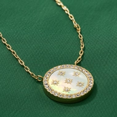 A woman wearing a gold-tone Sadie heart necklace.