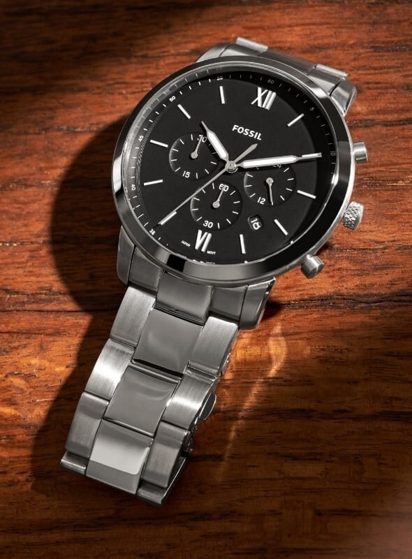 A stainless steel men's watch featuring a round black dial.