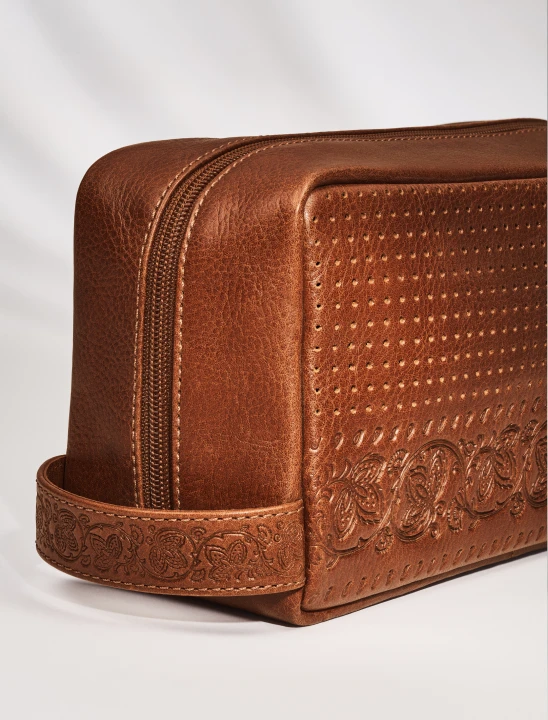 A Fossil brown leather dopp kit.