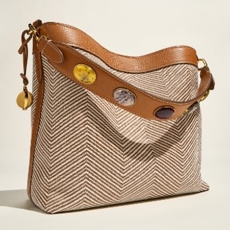 The brown leather Willa bag sitting on a blue chair.