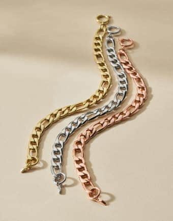 Three bracelets in gold-tone, rose gold-tone and silver-tone finishes. 