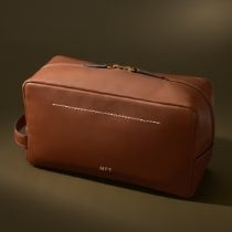 A brown leather shaving case.