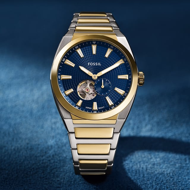 The sporty Everett watch in a two-tone finish with a blue dial revealing an automatic movement inside.