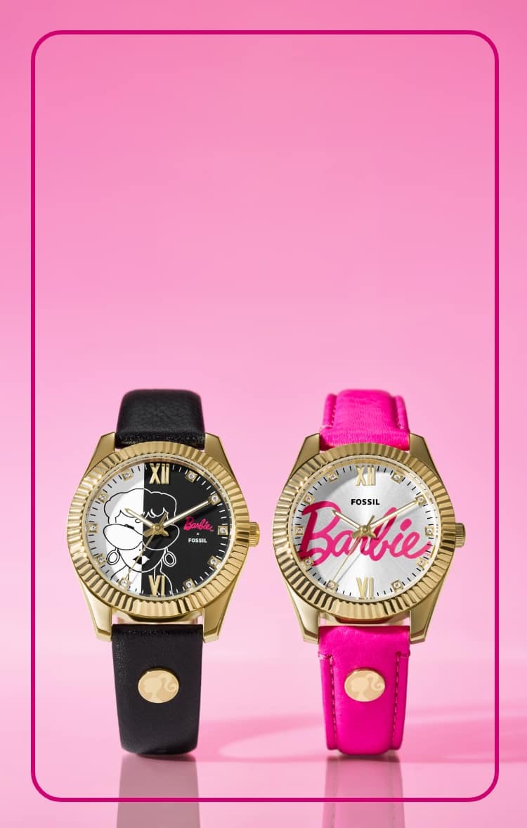Two special-edition Barbie watches are cuffed and displayed upright, side by side. The watch on the left features a graphic black-and-white dial with a vintage-inspired illustration of Barbie and a black leather strap. The watch on the right features the scripted Barbie signature on the dial in hot pink, complemented by a hot pink leather strap. Both styles are accented with a fluted, gold-tone topring.