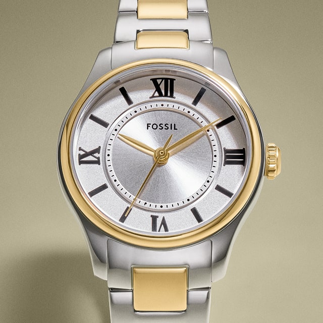 A round-faced, gold-tone watch with a silver sunray dial.