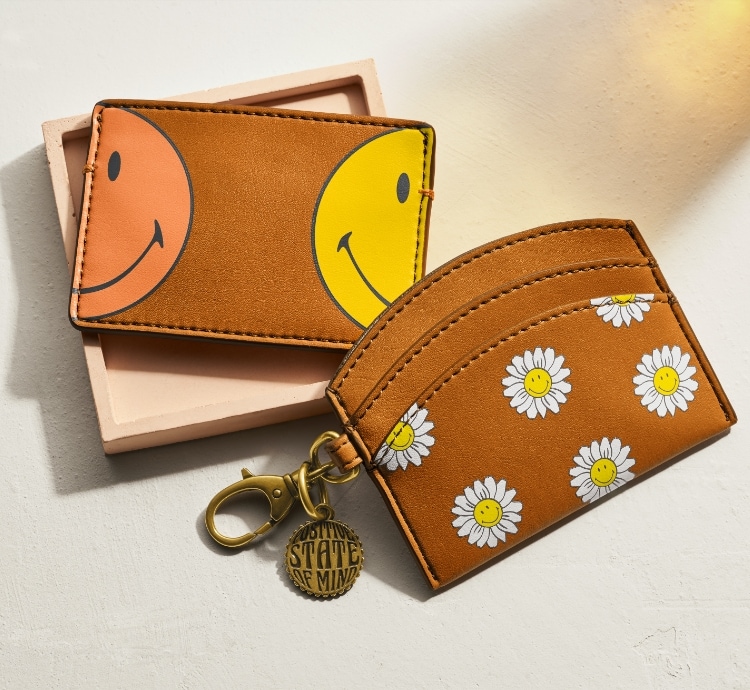 Vegan cactus Fossil x Smiley wallets. Smiling daisy graphics. 