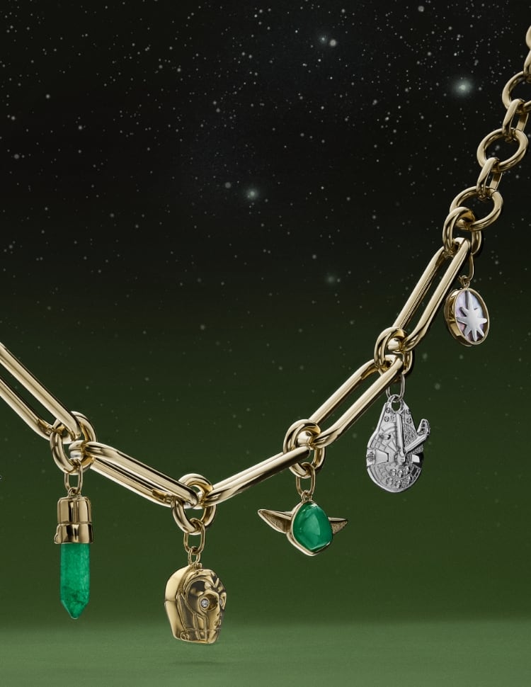 A gold-tone bracelet with charms shaped like Yoda, the Millennium Falcon, C-3PO, R2-D2 and a Lightsaber