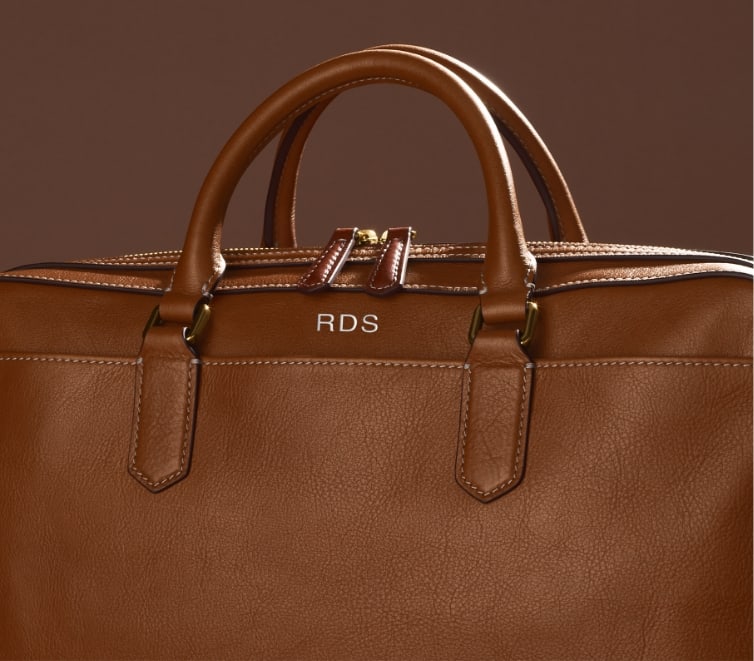 A brown leather bag embossed with RDS.