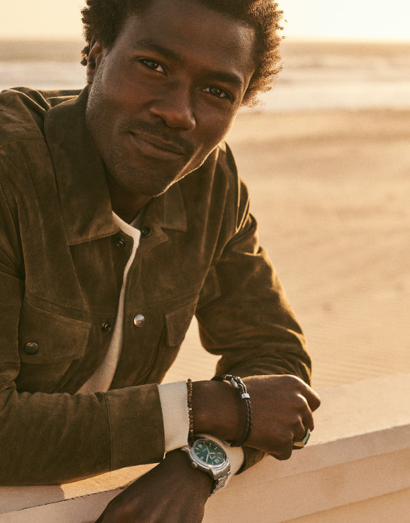 A man wearing the Fossil Heritage Automatic Stainless Steel watch with green dial