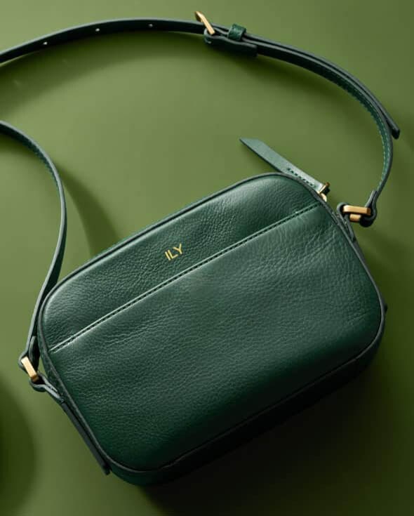 A green Liza Camera bag embossed with Joy.