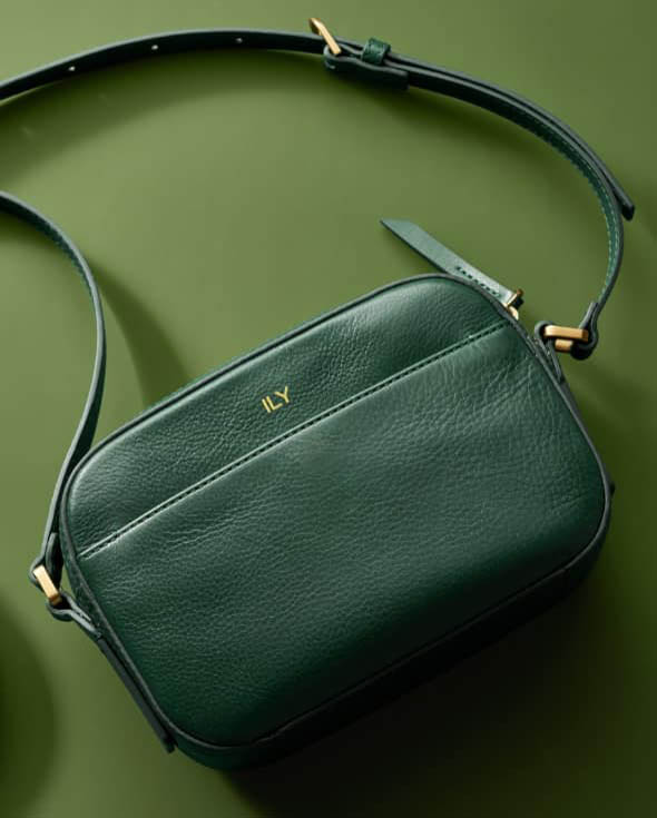 A green Liza Camera bag embossed with Joy.