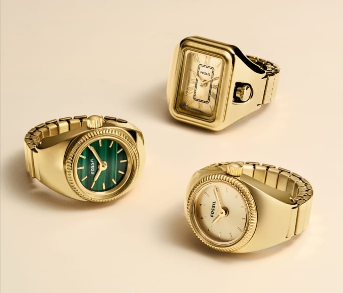Three gold-tone watch rings in a variety of case shapes and dial finishes.