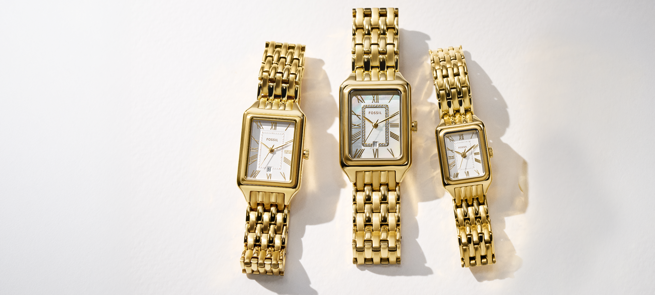 Three gold-toned Fossil Raquel watches in various sizes sit side-by-side on a white background.