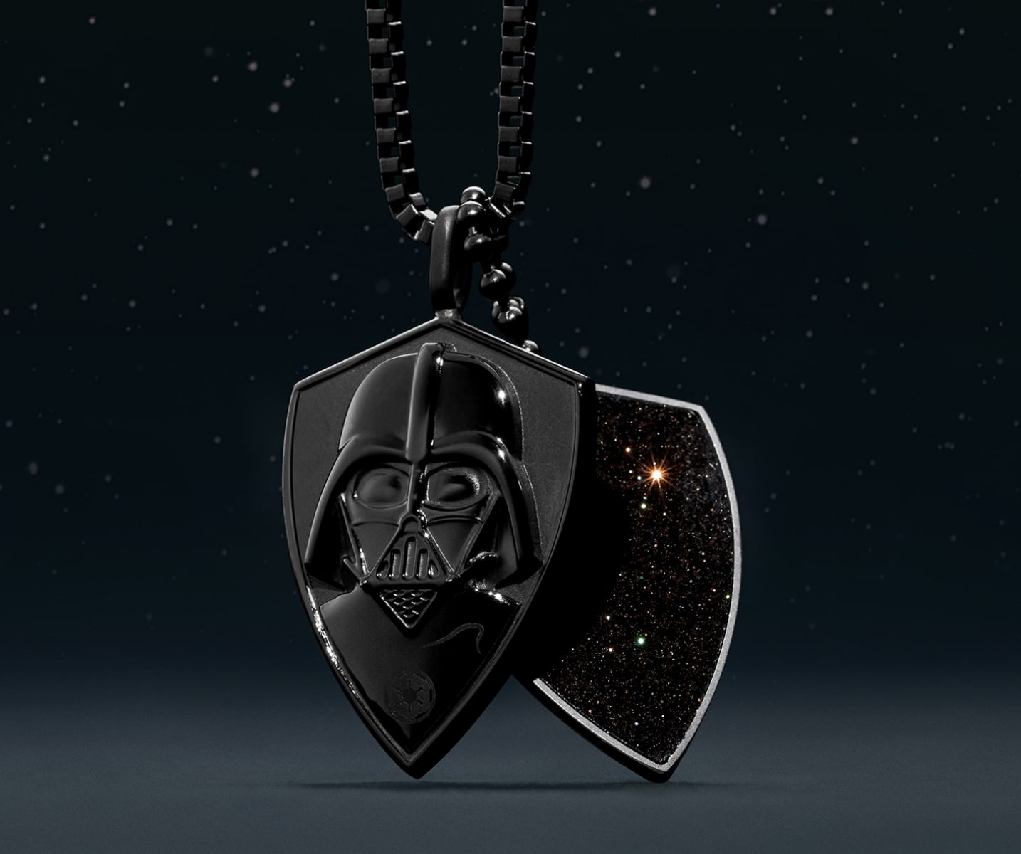 a black dog-tag style necklace with a relief of Darth's helmet