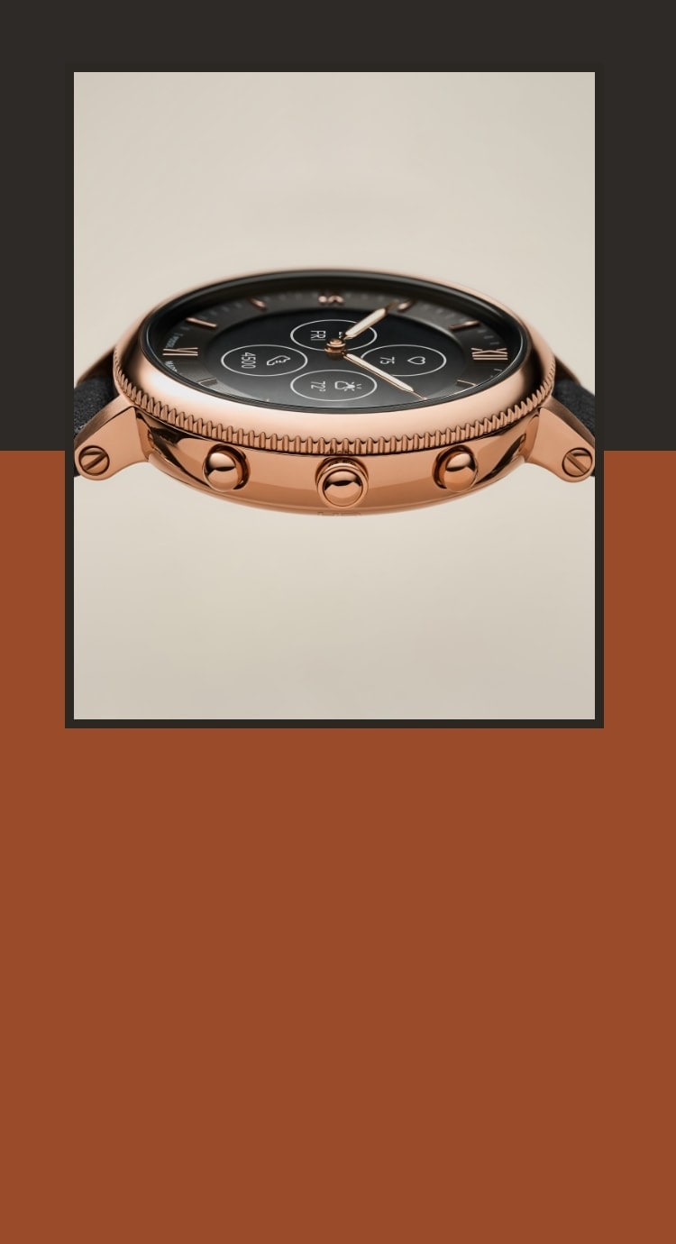 A closeup of a rose gold-tone Hybrid HR smartwatch on its side. 