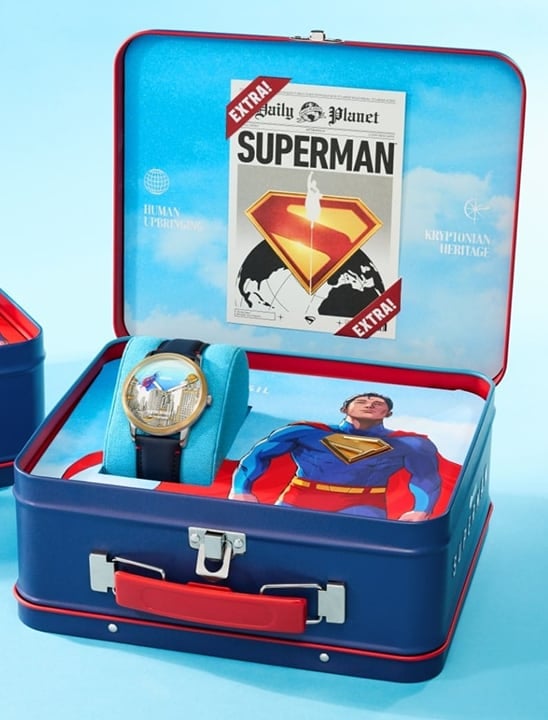 Image of Fossil x Superman watch in a box on a sky blue background.