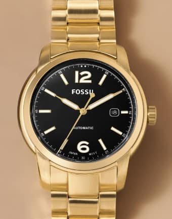 A gold-tone Fossil watch with black dial. 