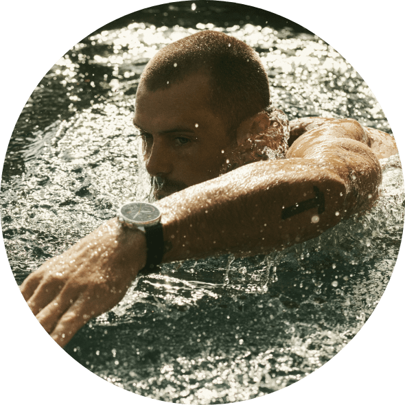 A man swimming while wearing a Gen 6 Wellness Edition smartwatch. 