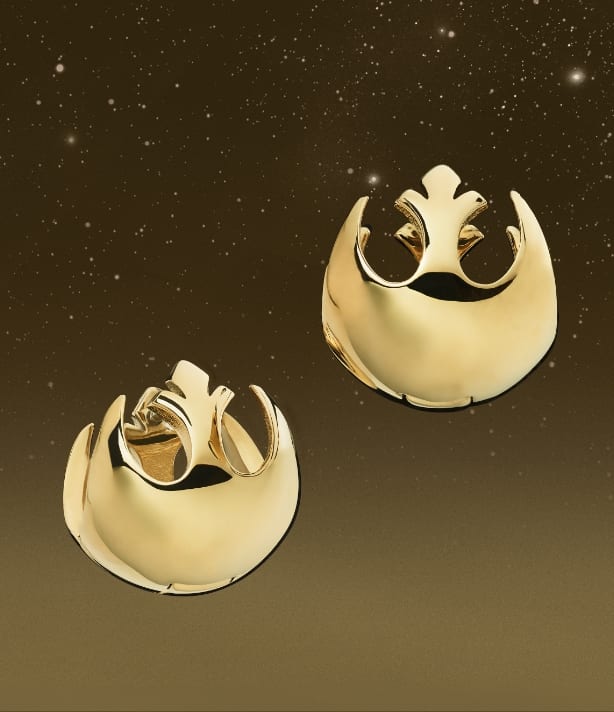 Gold-tone huggie earrings in the shape of the Rebellion symbol