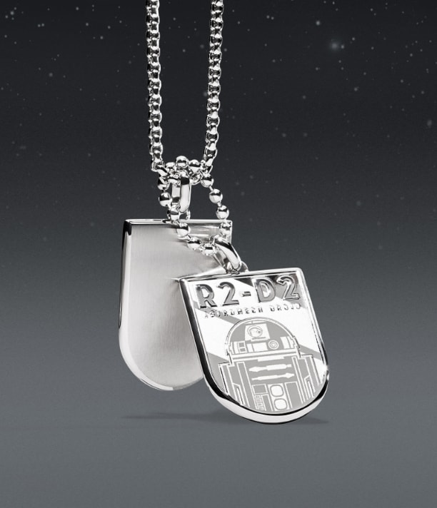 A silver-tone necklace with an engraving of R2-D2 on an ID plaque