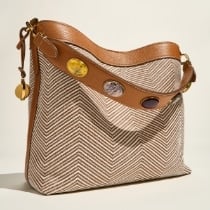 The brown leather Willa bag sitting on a blue chair.