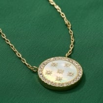 A woman wearing a gold-tone Sadie heart necklace.