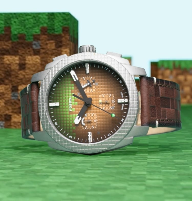 In daytime view, a green-and-brown men's watch with a block texture is shown against a pixelated landscape inspired by Minecraft.