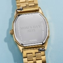The engravable caseback on a gold-tone watch.
