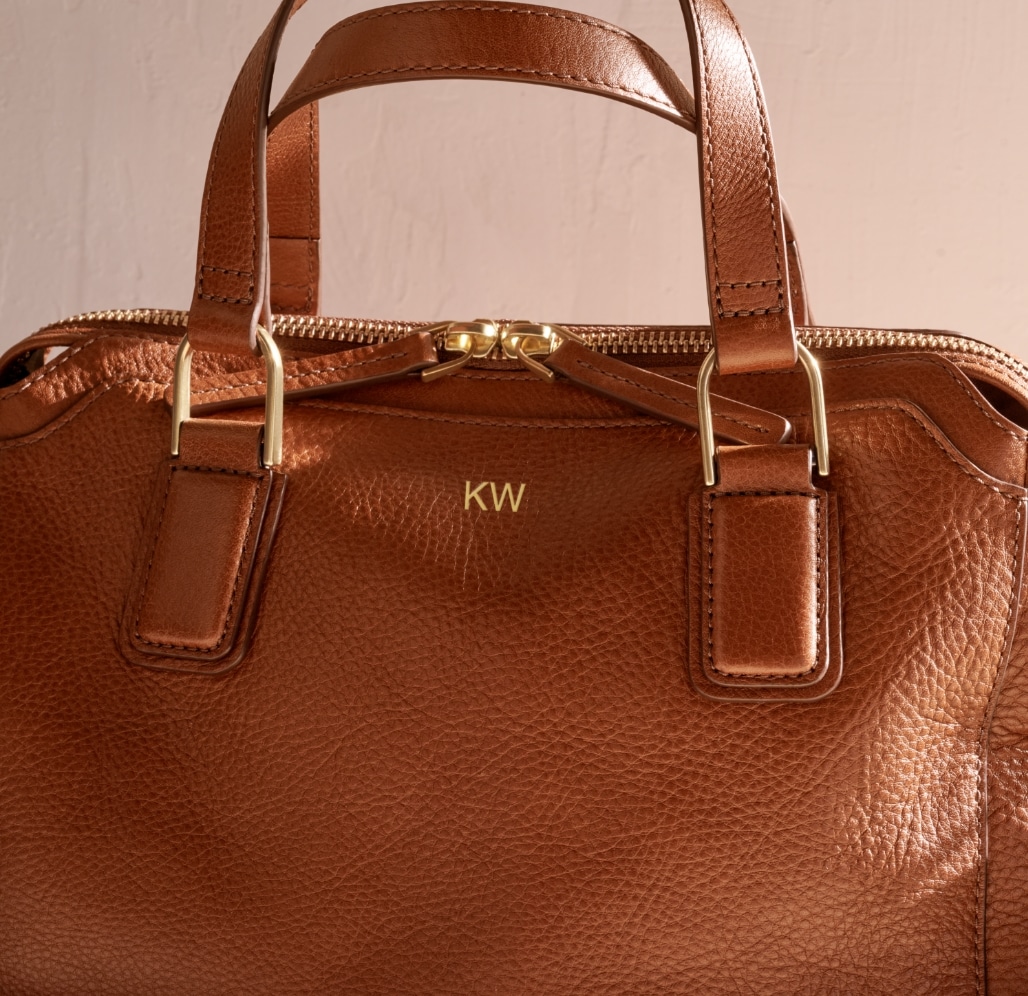 Brown leather bag with KW embossed on it. 