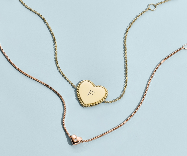 a pair of fossil heart necklaces