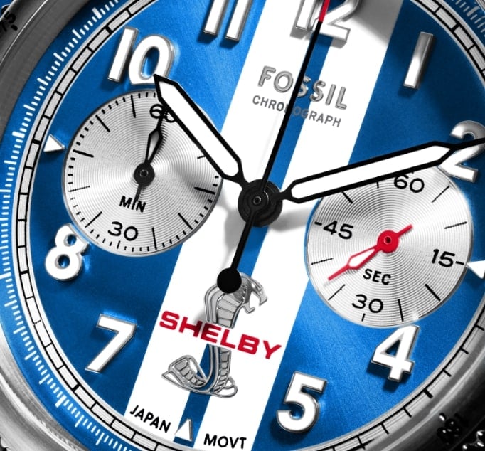 A closeup view of the limited-edition Shelby Grand Tourer chronograph watch, featuring the iconic blue and white striped dial, and stainless steel case and bracelet.