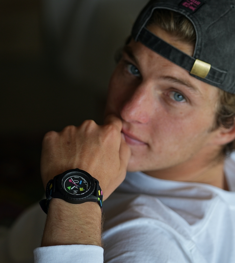 A man wearing the custom-designed Maui and Sons x Fossil hat and FB-01 Solar watch with Maui and Sons logo.