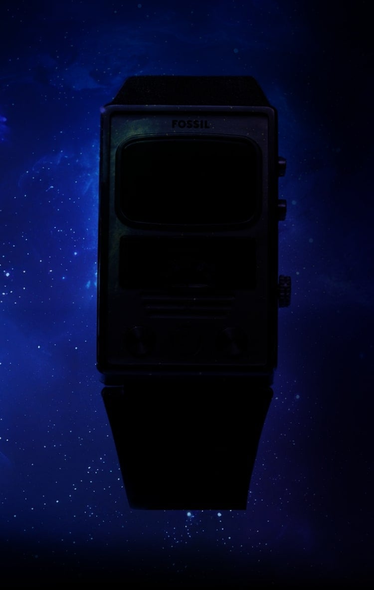 A blurred view of two watches on a dark, intergalactic background.
