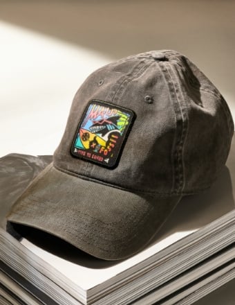 Maui and Sons hat sitting on top of a stack of paper.