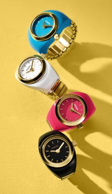 Four watch rings in turquoise blue, white, hot pink and black.