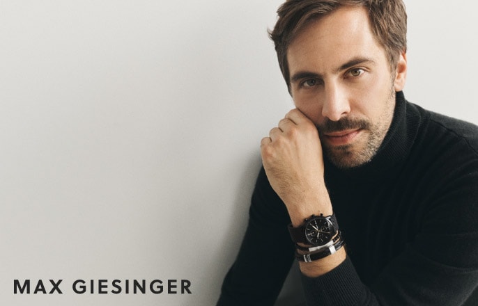 Max Giesinger is sitting. He's wearing the Minimalist Chrono watch and Fossil's leather and Beads bracelets.