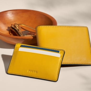 Two yellow leather wallets. 