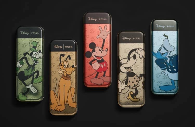 A GIF image featuring collectible tins for each of the five character watches celebrating the Mickey and friends characters. Shown from left to right: Goofy, Pluto, Mickey Mouse, Minnie Mouse and Donald Duck. The second image shows a group shot of the five anniversary watches. The D100 logo is featured beneath, celebrating Disney's 100th anniversary, followed by the Disney and Fossil logo lockup.