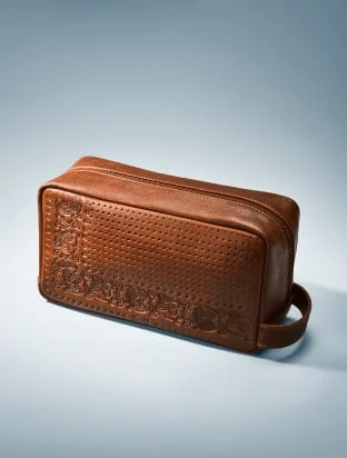 A Fossil brown leather dopp kit.