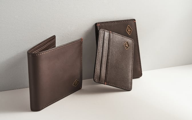 Three brown leather wallets.