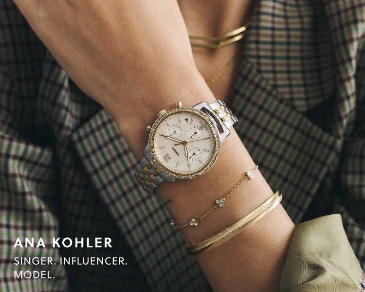 Zoom on Ana's wrist wearing the two-tone Neutra chronograph watch and two golden bracelets from Fossil's autumn collection.