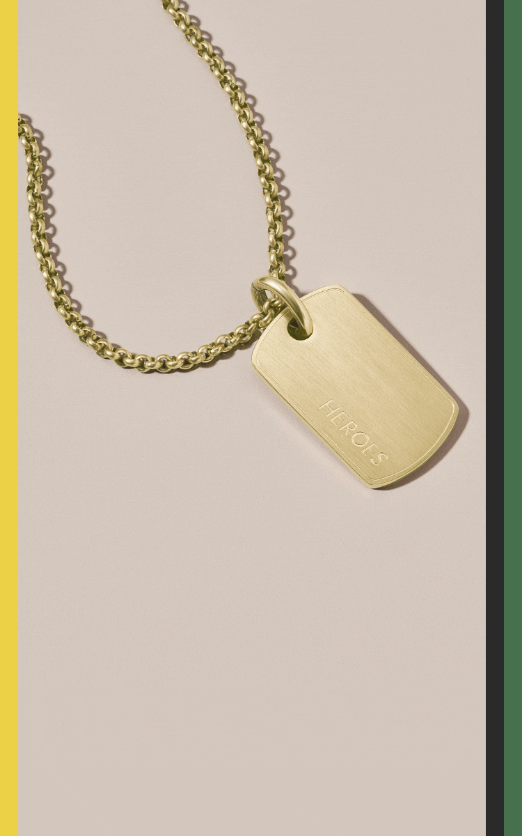 A gold-tone limited-edition necklace inscribed with the word Heroes and first names of important Black historical figures on the back.