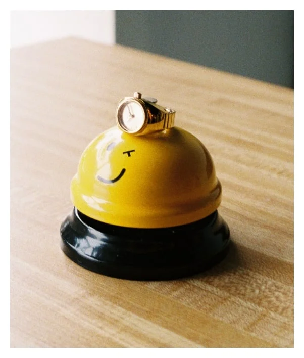 A yellow bell ringer with a winking face.