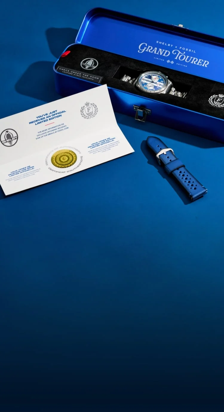 A royal blue auto toolbox-style display box, presenting the Shelby Grand Tourer watch inside, along with the interchangeable blue leather strap and certificate of authenticity.